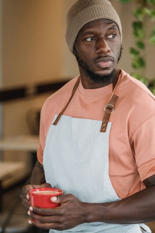 Barista wearing an apron for customer-facing work